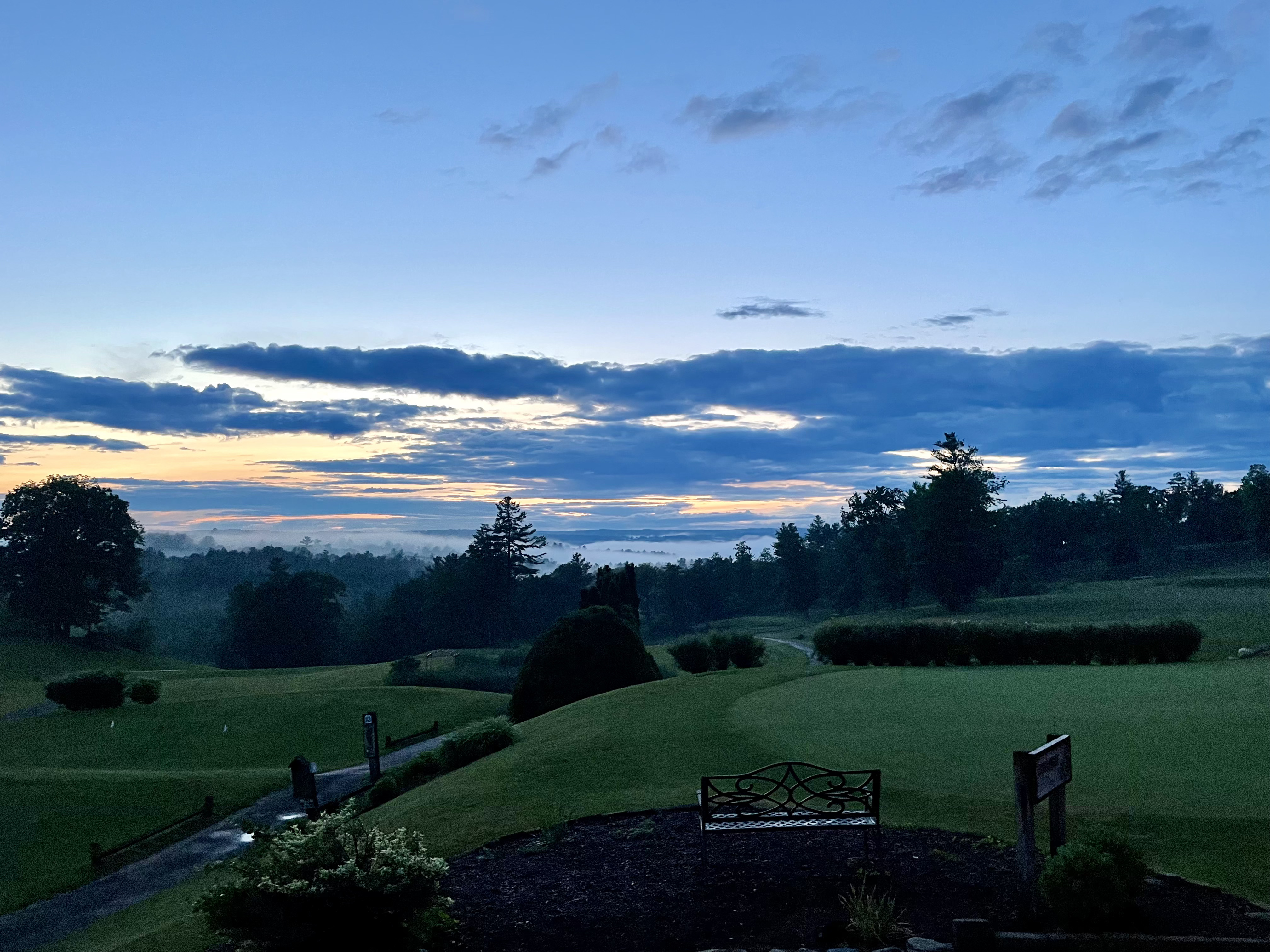 Golf course beneath twilight blue sky