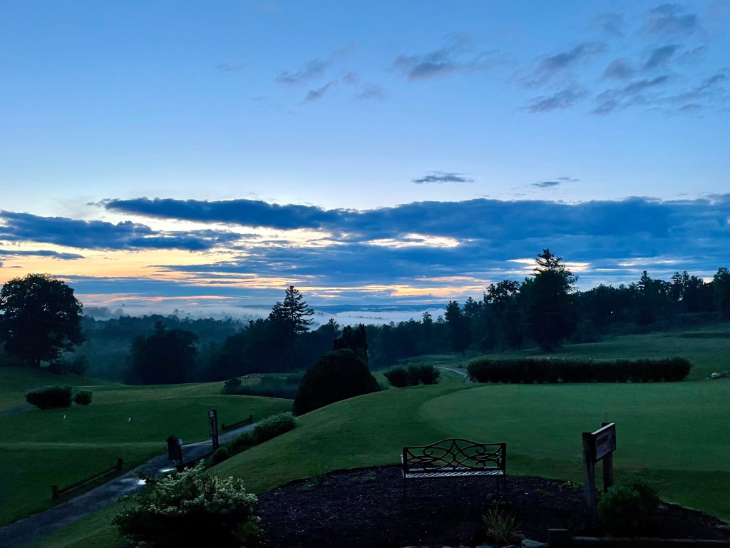 Golf course beneath twilight blue sky